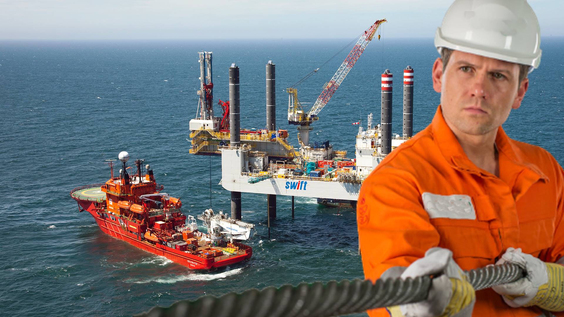 Plataforma de petróleo e um navio de apoio offshore e um homem de uniforme laranja segurando um cabo de aço