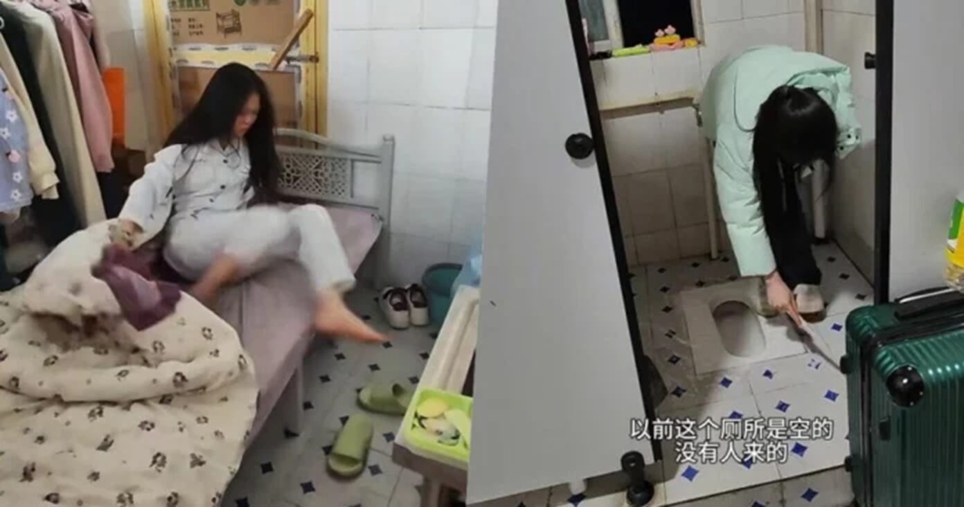 Mulher vivendo em condições improvisadas dentro de um banheiro, com cama ao lado do vaso sanitário no ambiente apertado e adaptado como moradia.