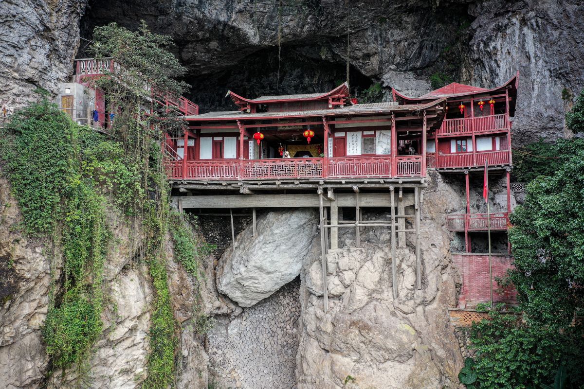 Na casa no penhasco de Fangguangyan, em Fujian, uma caverna abriga templo suspenso que desafia a engenharia e transforma a montanha em santuário vertiginoso.