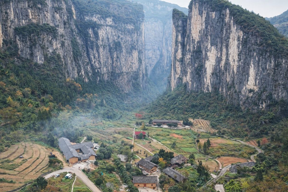 Vila Huilong fica escondida num desfiladeiro remoto de Chongqing dois paredões de 600 metros formam um portão de 400, cercam a dolina e deixam casas de barro isoladas no fundo da montanha (1)