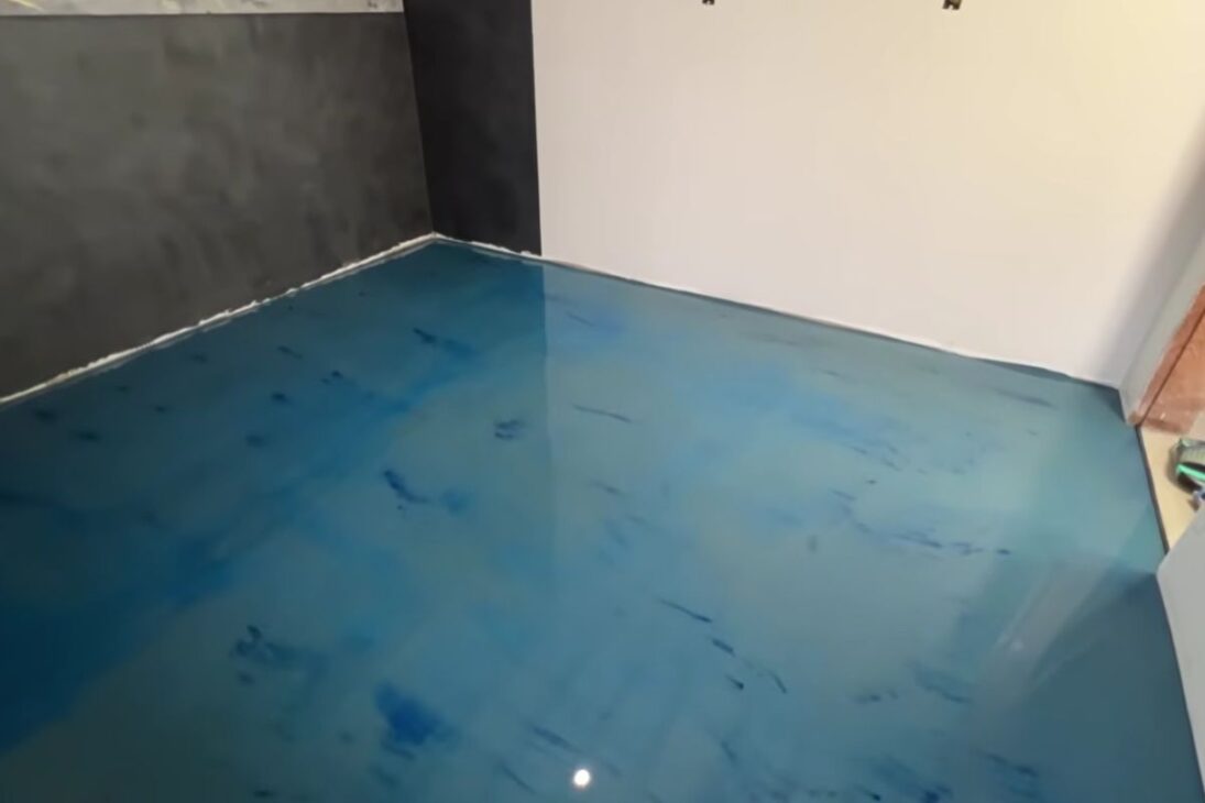 Piso líquido pigmentado con cemento autonivelante, resina y pigmento azul transforma casa, estudio y garaje con pocos milímetros y acabado moderno.