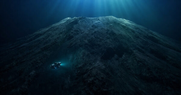 Submarino científico explorando o Maciço Tamu, gigantesca montanha vulcânica submersa no fundo do Oceano Pacífico iluminada por raios de luz vindos da superfície.